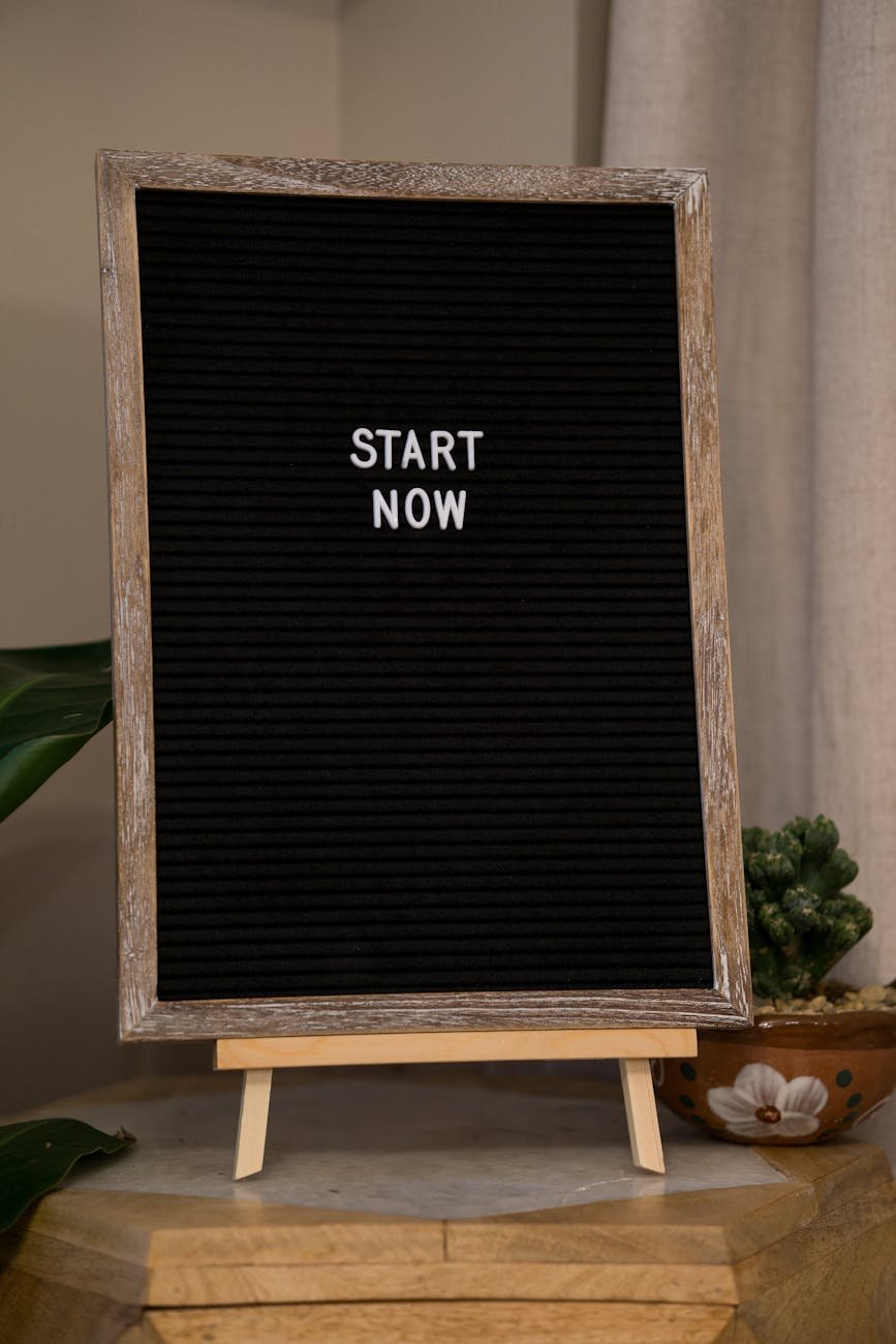 inspirational black board with start now message